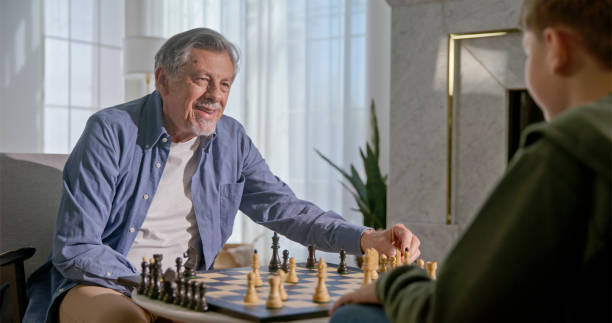 istock Caucasian Grandfather and Grandson Enjoying a Chess Game 2201682362