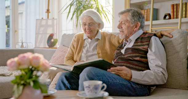 istock Senior Couple Cherishing Memories on Cozy Sofa 2201682463