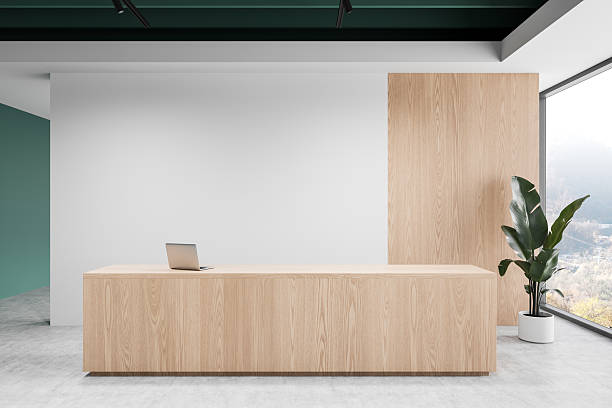 Modern reception desk with laptop and plant in a bright interior. 3D Rendering