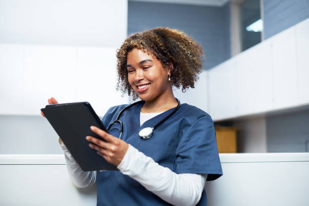 istock Smiling Healthcare Professional Using Digital Tablet in Modern Office 2201682744