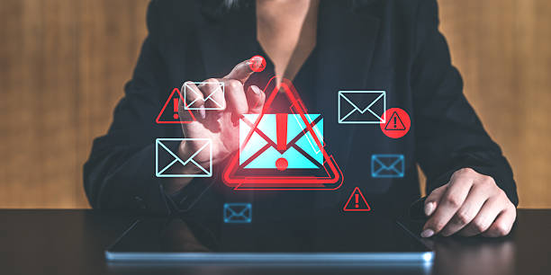 istock Businesswoman interacting with email warning icon on tablet screen. 2201682862