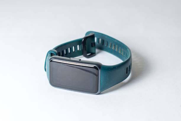 istock Modern smart watch with teal band on neutral background. 2201684326