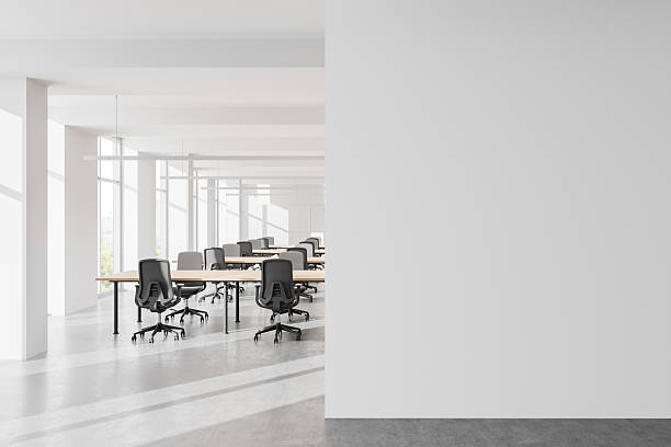 istock Modern open-space office interior with large windows, cityscape view, and rows of desks and chairs. 3D Rendering 2201685617
