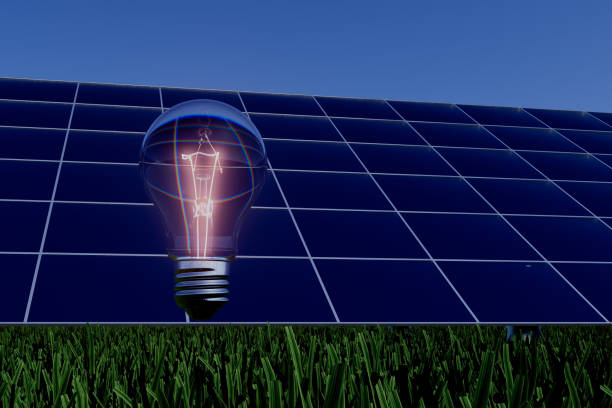 A light bulb is lit up in a field of grass. The light bulb is glowing brightly, illuminating the grass and the sky. Concept of warmth and brightness, as if the light bulb is a symbol of hope