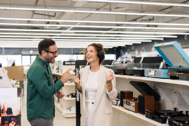 istock Couple shopping for audio equipment in a modern electronics store 2201688549