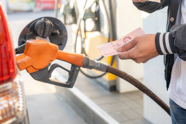 istock A man is paying for fuel with cash. 2201690342