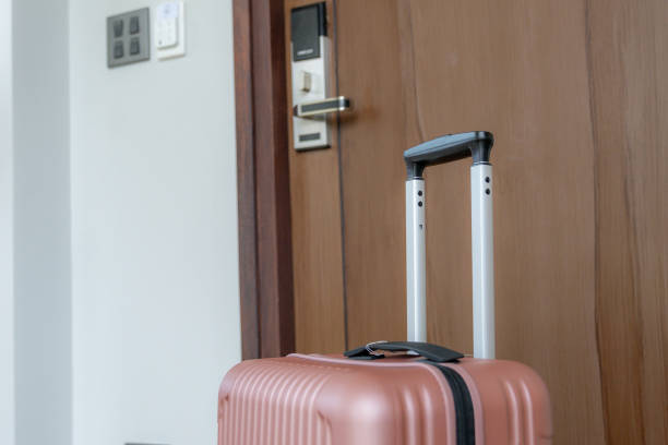 istock A suitcase is in front of the hotel room. 2201690395
