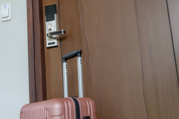 istock A suitcase is in front of the hotel room. 2201690400