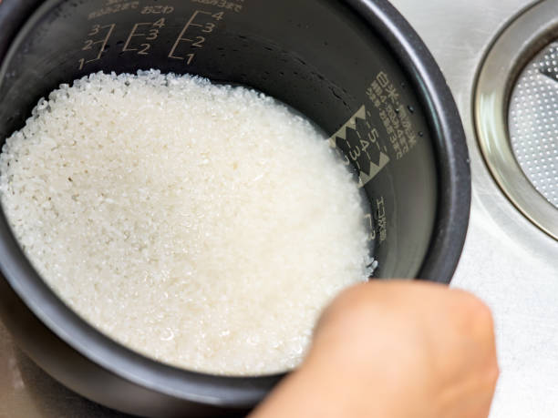 istock Rinse the rice in the kitchen sink 2201690529