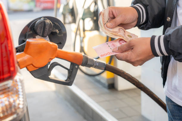 istock A man is paying for fuel with cash. 2201690738