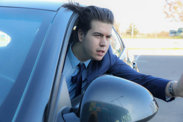 istock Young Successful Businessman Arguing with the Driver in Front While Driving 2201692101