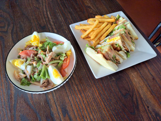 Chicken Salad With Chicken Meat, Boiled Eggs And Fresh Vegetables. Chicken Sandwich With Chicken Meat, White Bread, Vegetables And French Fries. Food Menu.