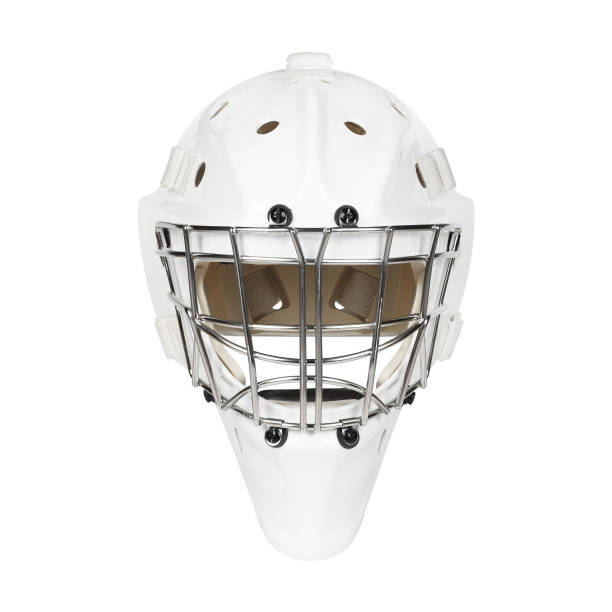A close-up shot of a hockey goalie mask resting on the net during a break in the game, with the blurred background of the arena stands.