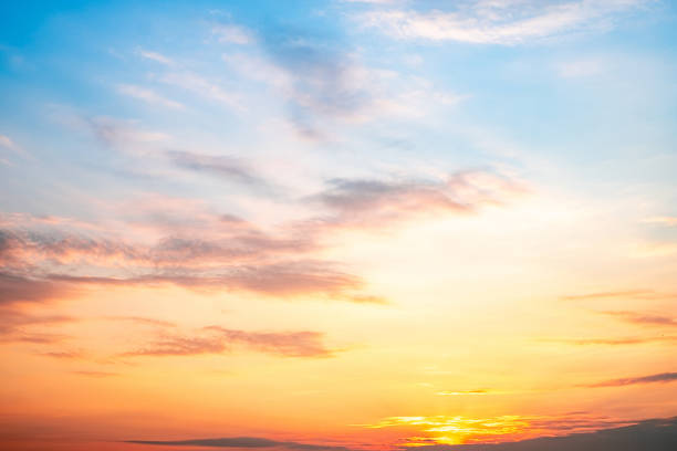 istock Sky,sunset, beautiful , luxury soft gradient orange gold clouds and sunlight on the blue sky perfect for the background, Sunrise on morning or everning in winter warm time ,Twilight summer,silhouette 2201695493