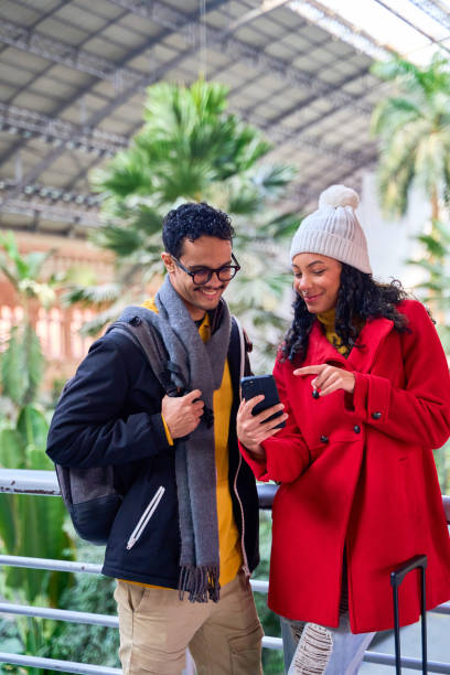 istock Tourists consulting smartphone inside atocha station in madrid 2201696185