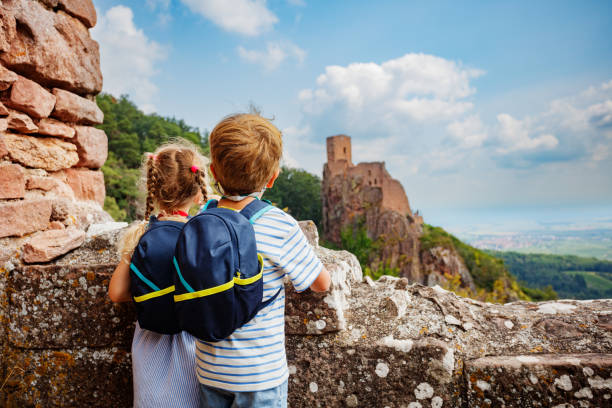 istock Two young adventurers look towards a picturesque castle Girsberg 2201697233