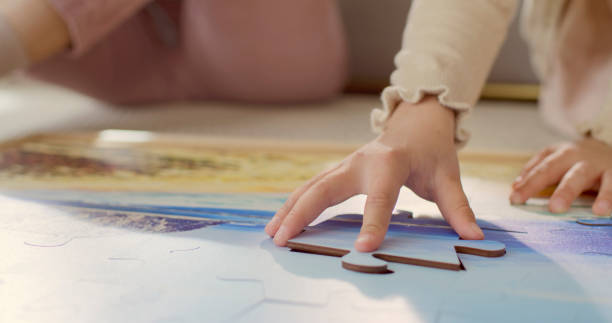 istock Young Girl Assembling Puzzle with Grandmother 2201698157