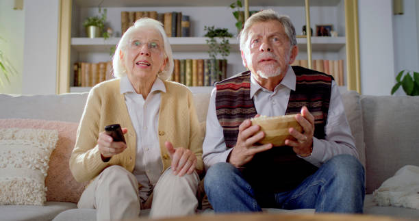 istock Senior Caucasian Couple Watching TV With Intensity 2201698193