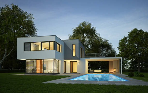 Modern white cubic villa with pool in the evening
