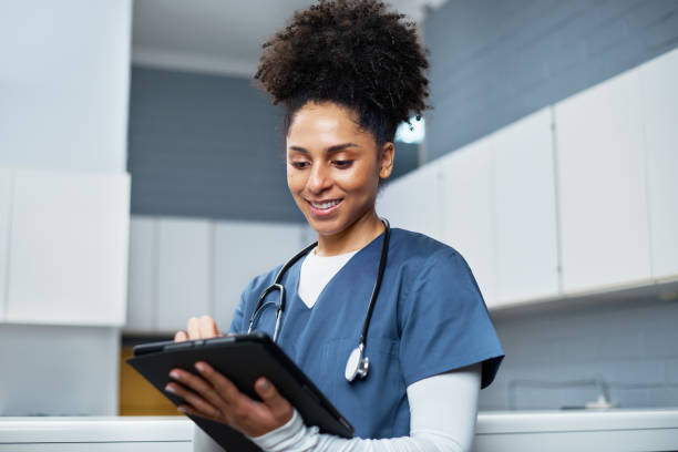 istock Smiling Healthcare Professional Using Tablet in Medical Environment 2201699129