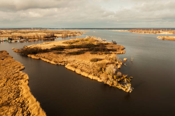 istock Autumn river landscape from a drone. Autumn plants by the river landscape. 2201699177