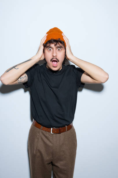 istock Portrait of shocked young man 2201699740