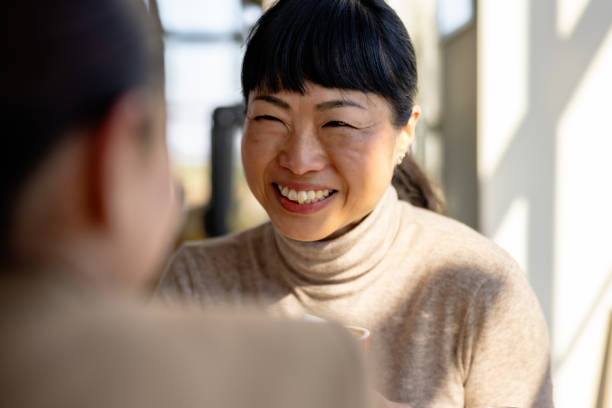istock Japanese woman in a cafe with a friend 2201700616