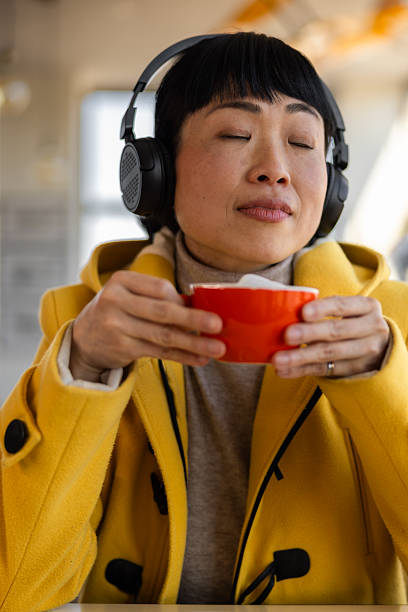 istock woman enjoying a cafe with headphones 2201700785
