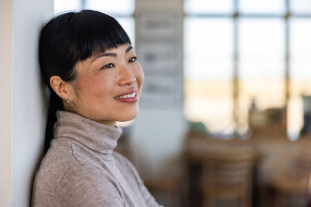 istock Japanese woman leaning on wall in caffe 2201700888