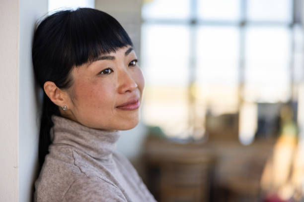 istock Japanese woman leaning on wall in caffe 2201700908