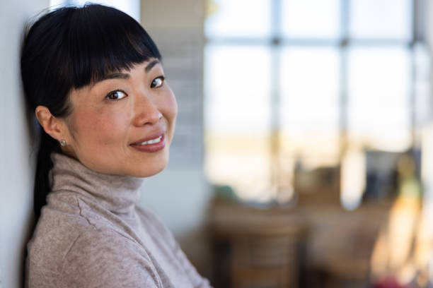 istock Japanese woman leaning on wall in caffe 2201700922