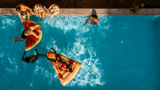 Colored floats in the water of a swimming pool, summer concept
