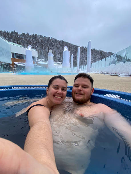 istock Couple Relaxing in Hot Tub During Winter 2201701482