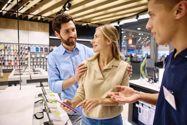 istock Exploring the shopping experience in a modern electronics store with customers and a salesperson 2201703923