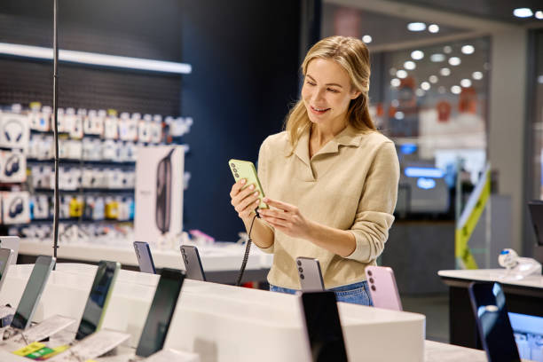 istock A Young Woman Engaged in Browsing the Latest Technology at an Electronics Store Today 2201703933