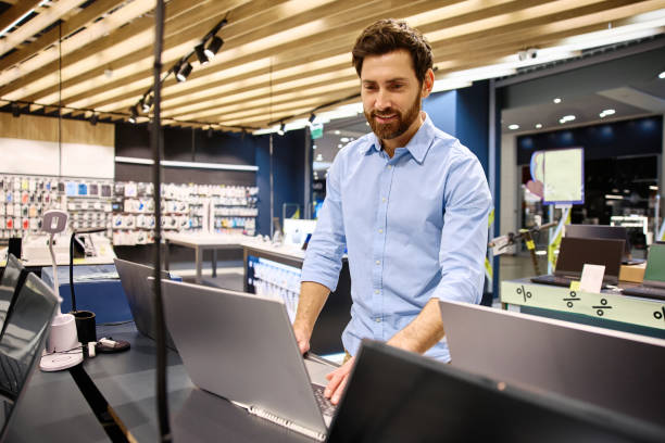 istock A Young Professional Enthusiastically Engaging with Laptops in a Modern Retail Store Environment 2201704000
