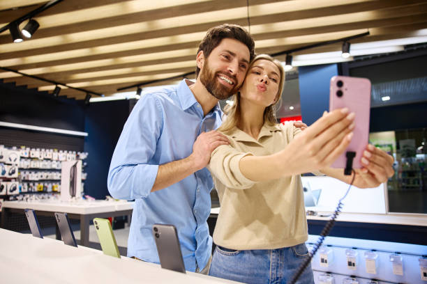 istock A couple happily taking a selfie together while browsing a smartphone in a mobile phone store 2201704028