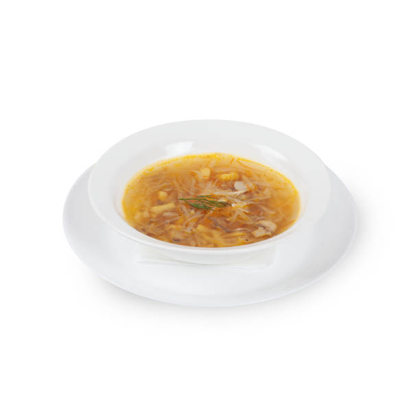istock Fresh soup in white bowl on plate isolated in white background 2201704098