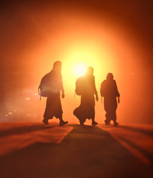 istock Refugees and immigrants.  Column of migrants crossing desolate lands. Desert 2201705456