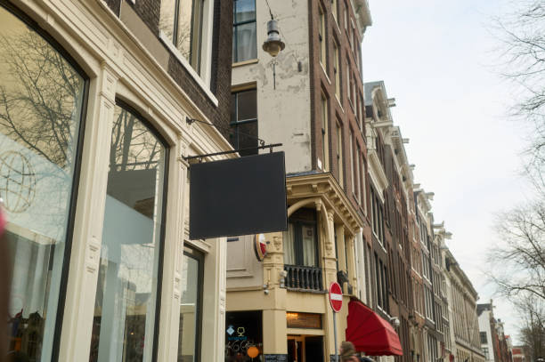 Empty black sign hanging on a building in amsterdam, netherlands