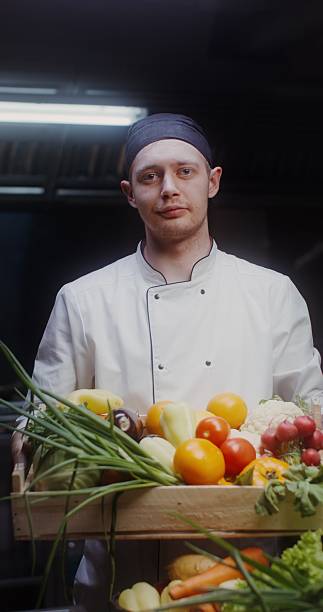 istock A man in a chef's uniform with vegetables in his hands 2201706165