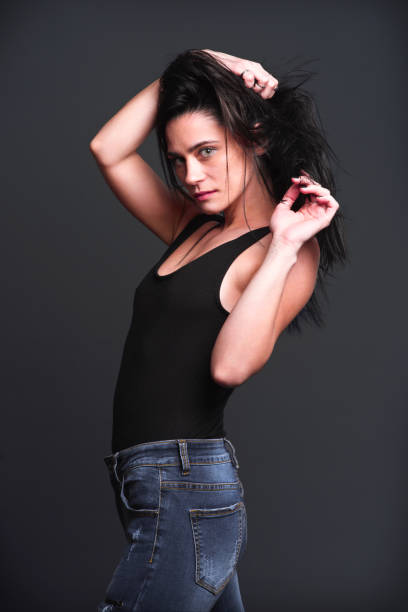 istock Model striking a confident pose in front of a dark background during a photoshoot 2201710180