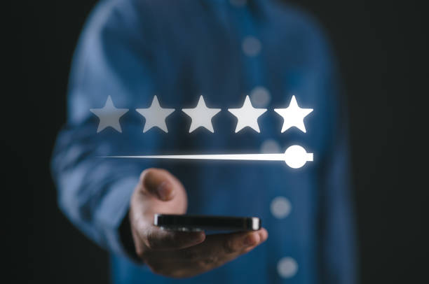 istock Client holding smartphone to review feedback to give five stars rating for customer evaluation and best excellent after use product and service concept. 2201712708