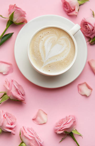 istock Heart latte art surrounded by pink roses 2201713574