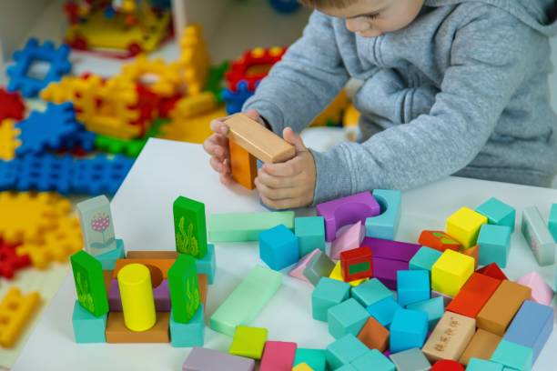 istock Children playing with toys in the room. Selective focus 2201714892
