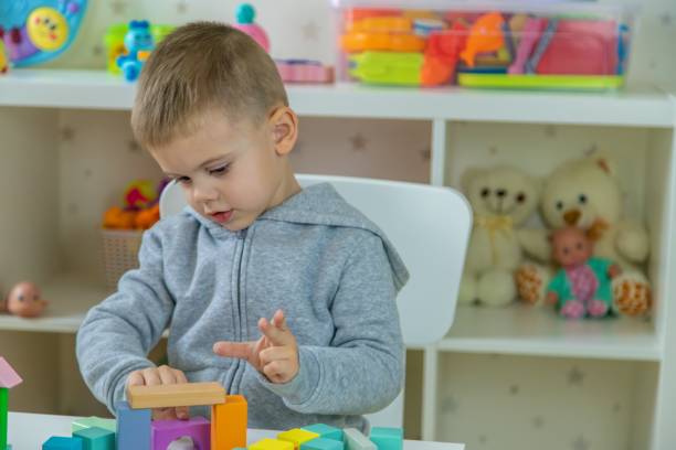 istock Boy playing with toys in the room. Selective focus 2201714895