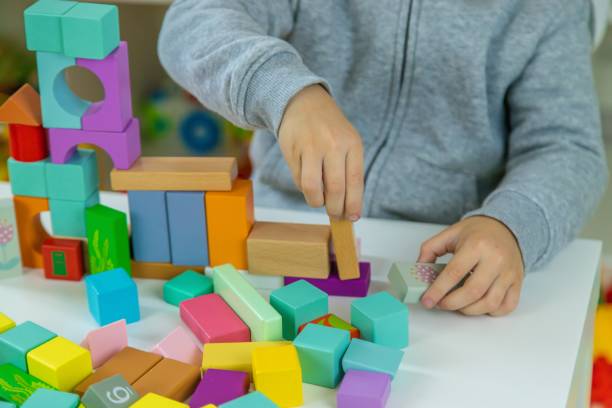 istock Boy playing with toys in the room. Selective focus 2201714913