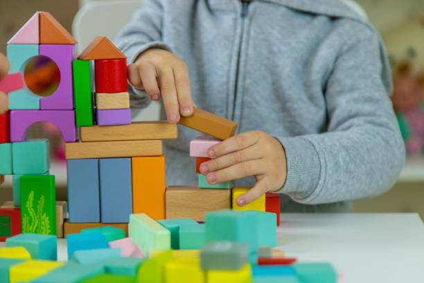 istock Boy playing with toys in the room. Selective focus 2201714926
