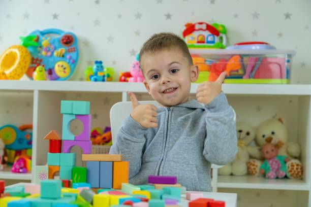 istock Boy playing with toys in the room. Selective focus 2201714927