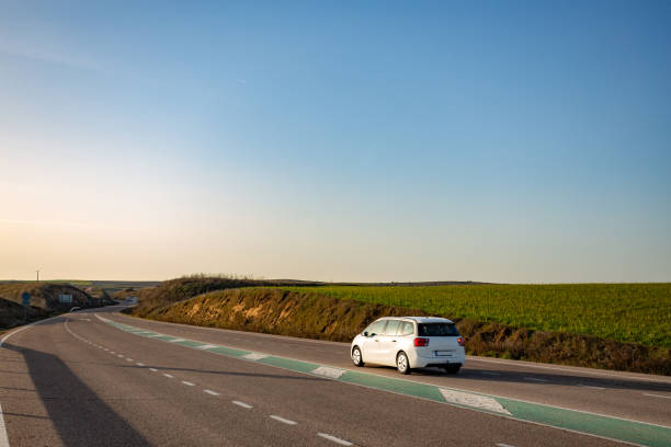 istock White car driving on scenic road at sunset 2201715615